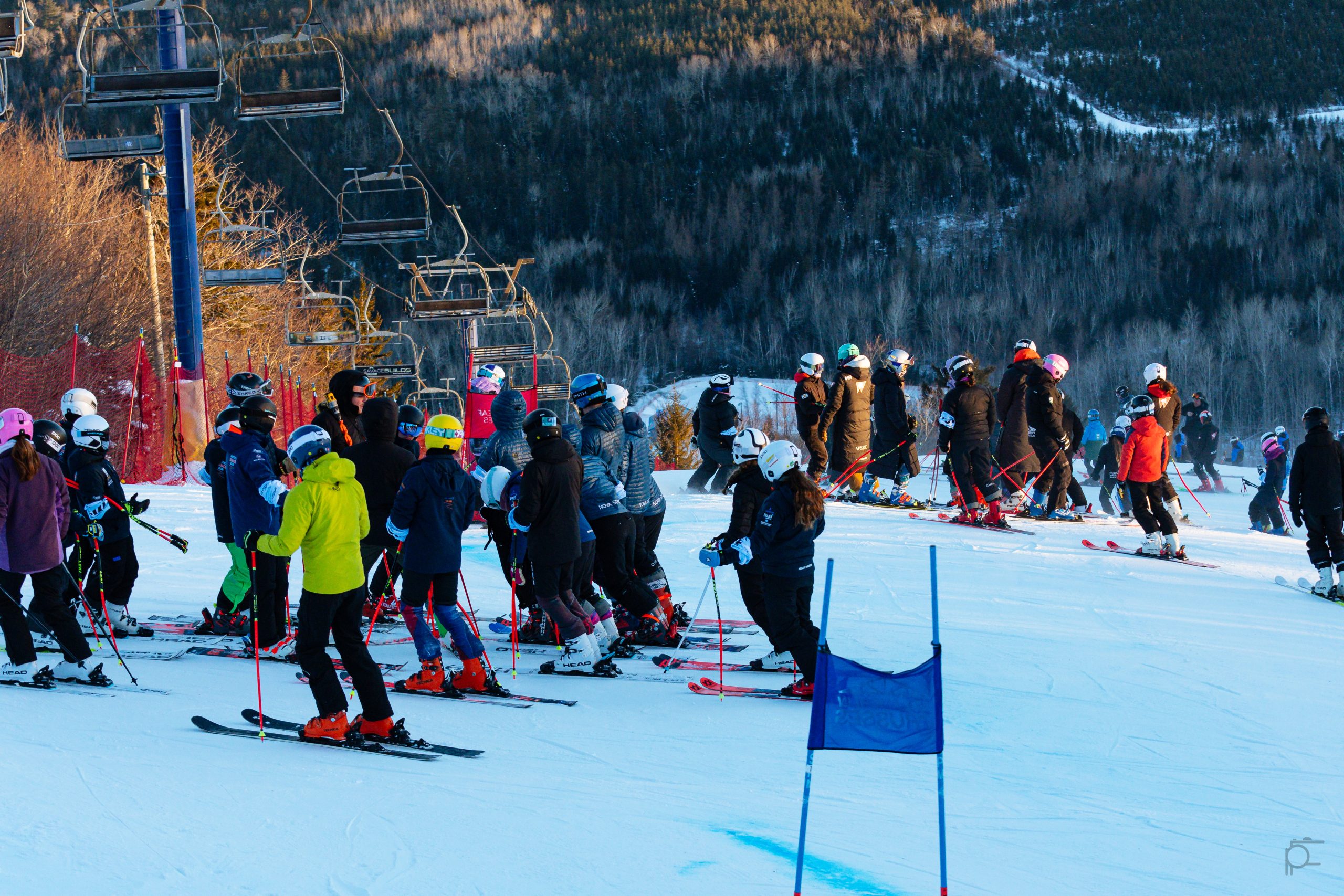 Young athletes and coaches gathered on a ski hill
